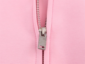 Macro detail of high-quality silver metal zipper on pink knitted pilot jacket fabric