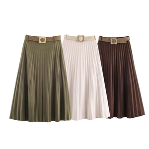 Close-up of pleated midi skirts in olive, beige, and brown with matching gold-buckle belts