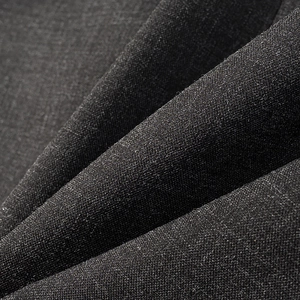 Close-up of premium black woven fabric texture with matte finish for high-end blazers