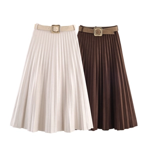 Detail view of high-waist pleated midi skirts with matching belts in cream and brown