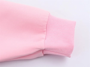 Detailed macro view of pink ribbed cuffs on a cotton bomber jacket with fine stitching