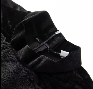 Detail of elegant black velvet dress with delicate lace embroidery and back zipper closure