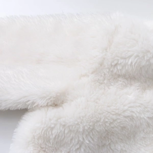 Close-up of high-quality fluffy white faux fur texture on a winter hooded jacket