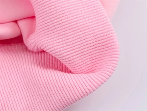 Close-up of pink ribbed cuffs on a flight jacket with fine knit texture detail