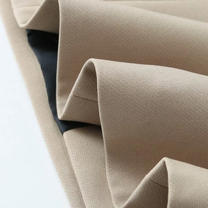 Detailed macro view of khaki blazer fabric texture with black inner lining stitch