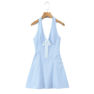 Detail of white lace trim on deep V-neck and bow of light blue striped dress