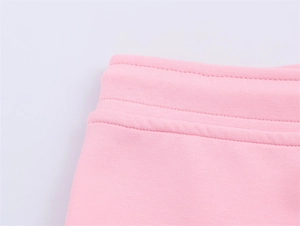 Macro detail of soft pink knit cotton fabric with professional double-needle stitching