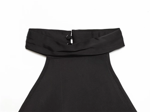 Detail of black halter top neckline with elegant pleated fabric and twin button closure