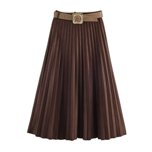 Close-up of deep brown pleated midi skirt with suede effect and gold buckle belt detail