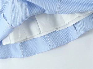 Detail shot of blue and white striped dress hem showing high quality stitching and lining