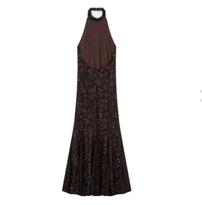 Detail of dark brown halter neck dress showing sequin floral embroidery on the skirt
