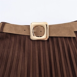 Detail of dark brown pleated midi skirt featuring a faux suede finish and a belted waist