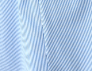 Detailed close-up of blue and white striped cotton fabric texture for summer dresses