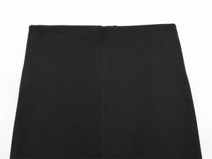 Detail of elegant black high waist skirt featuring fine matte texture and neat stitching