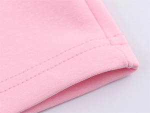 Detailed macro view of pink knit bomber jacket with precise double-needle stitching