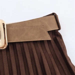 Detailed shot of dark brown pleated skirt featuring a waist belt with golden buckle