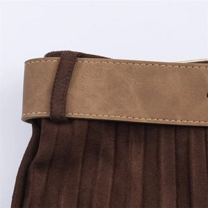 Detail of suede-effect pleated midi skirt with brown wide belt and contrast stitching