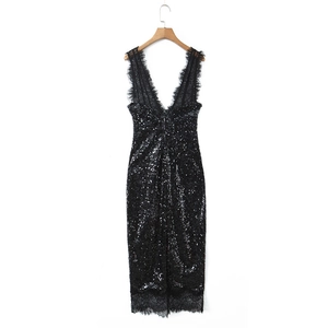 Detailed close-up of a black sequin dress with deep V-neck and delicate lace trim