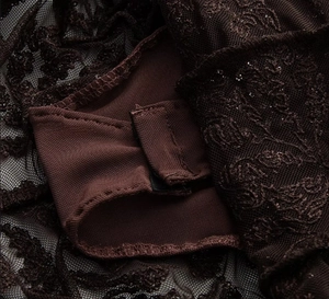Close-up of brown lace bodysuit showing embroidery detail and crotch hook closure