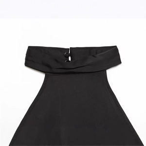 Chic black halter top with high neckline and back button closure detail on flat lay