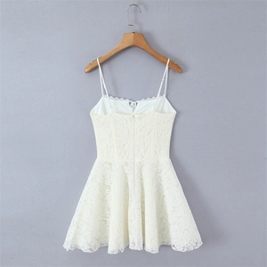 Detail showing white lace floral texture and back invisible zipper of the mini dress