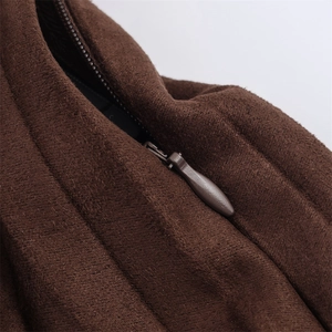 Detailed macro view of dark brown suede midi skirt featuring a concealed zipper closure
