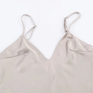 Detailed view of the champagne satin fabric and delicate V-neck stitching on the camisole