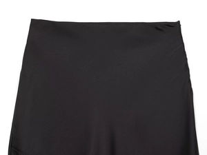 Macro shot of minimalist black high-waist skirt with sleek satin finish and clean lines