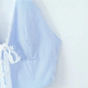 Deep V-neck striped dress featuring delicate white floral lace trim and bow details