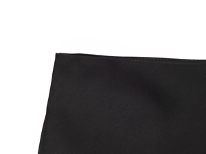 Detail of professional machine stitching and premium black lace fabric texture on skirt