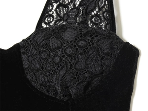 Dettaglio dell'abito in velluto nero con pizzo floreale e coppe in stile corsetto
