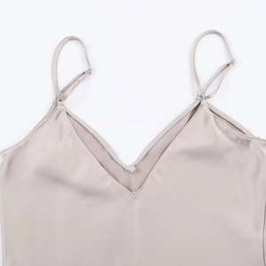 Detailed macro view of V-neckline with adjustable silver buckles on satin camisole