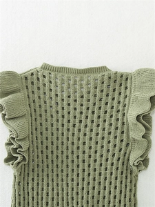 Détail du tissu en maille ajourée vert herbe avec bordures à volants élégantes