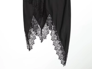 Close-up of black lace patchwork and irregular hem detail on midi skirt