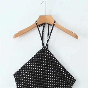 Polka dot halter neck backless dress for women in black with white dots on hanger