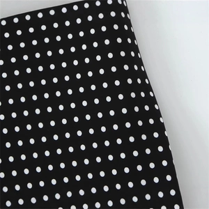 Chic black and white polka dot halter backless dress for a classic vintage summer look