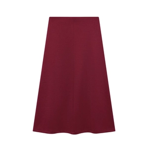 Detailed view of dark red A-line skirt fabric and minimalist knit waist construction