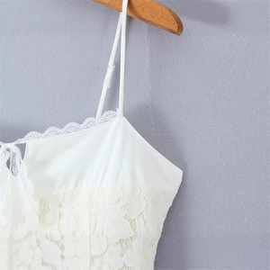 White lace camisole dress with adjustable spaghetti straps and floral lace textures