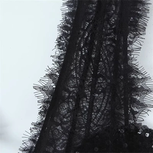 Slim fit black lace dress with intricate floral patterns and sparkling sequin trim