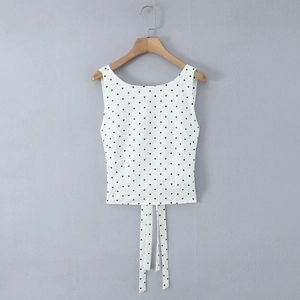 Detailed view of polka dot sleeveless top with long waist ties and back lace-up design