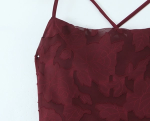 Close-up of wine red burnout rose fabric detail and delicate crisscross straps