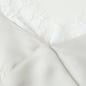 Elegant satin slip dress with lace trim in light gray showing high-quality fabric texture