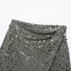 Green sequin mini skirt with silver wavy sparkle pattern and elegant mesh fabric detail