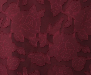 Close-up of burgundy red fabric with 3D embossed rose flower lace patterns