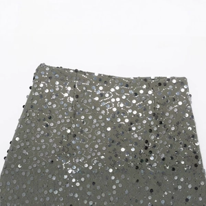Olive green mini skirt with wavy silver sequins and minimalist smooth waist detailing
