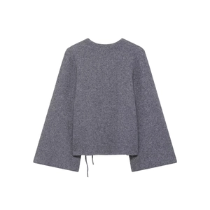 Détail d'un pull gris en tricot avec poignets fendus et ourlet à cordon de serrage