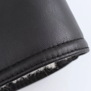 Detail of black faux leather jacket featuring premium stitching and thick grey plush lining