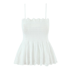 Close-up of white smocked camisole top with delicate floral embroidery and ruffled hem