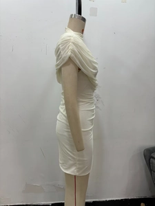 Detail of white bodycon dress featuring draped mesh neckline and slim fit silhouette