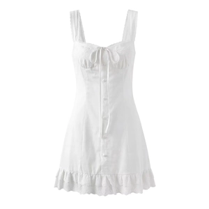 Detail of white sleeveless dress with eyelet lace hem and tie-up bow on front